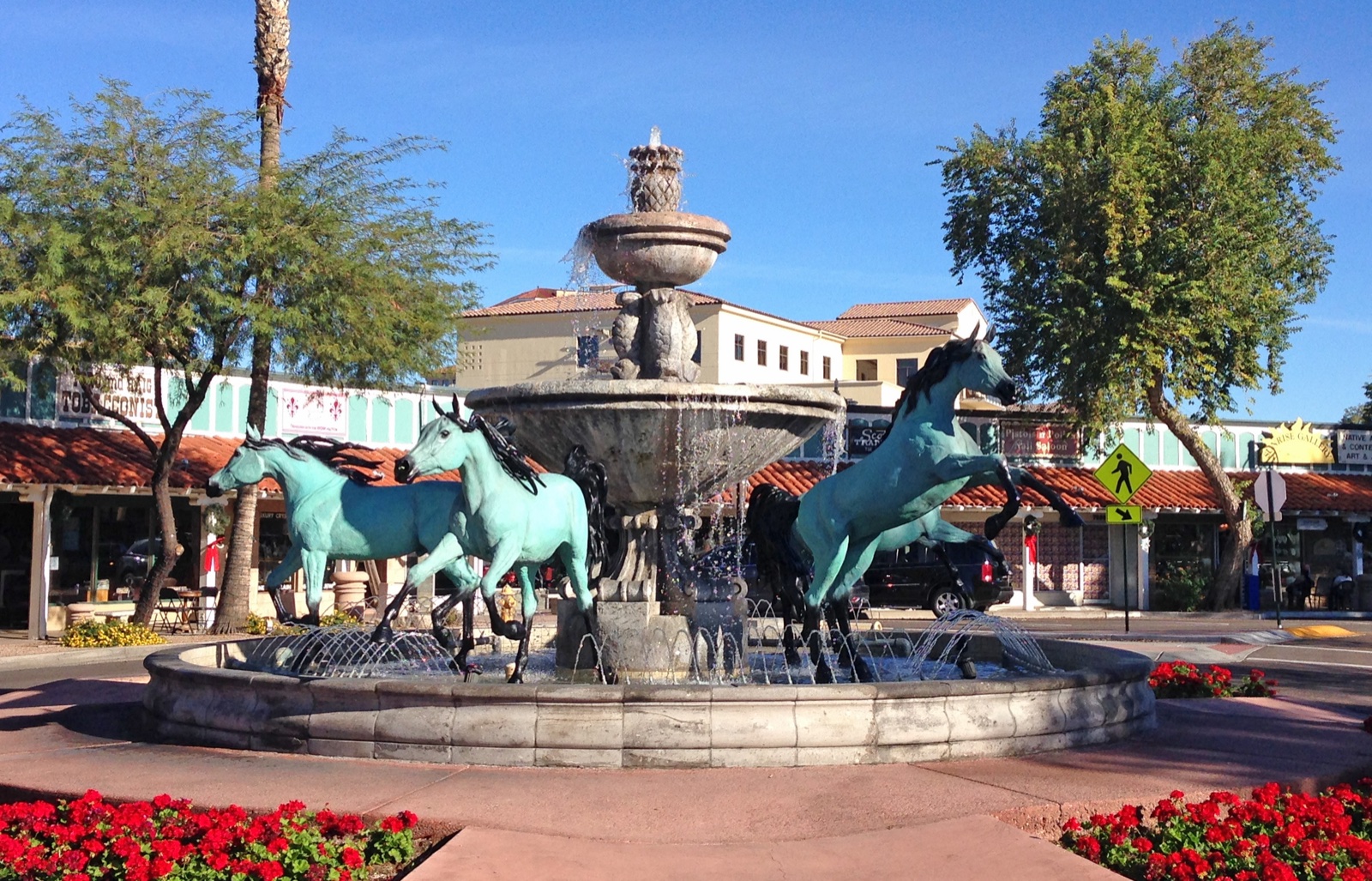 The Scottsdale Waterfront district with a fountain and palm trees
